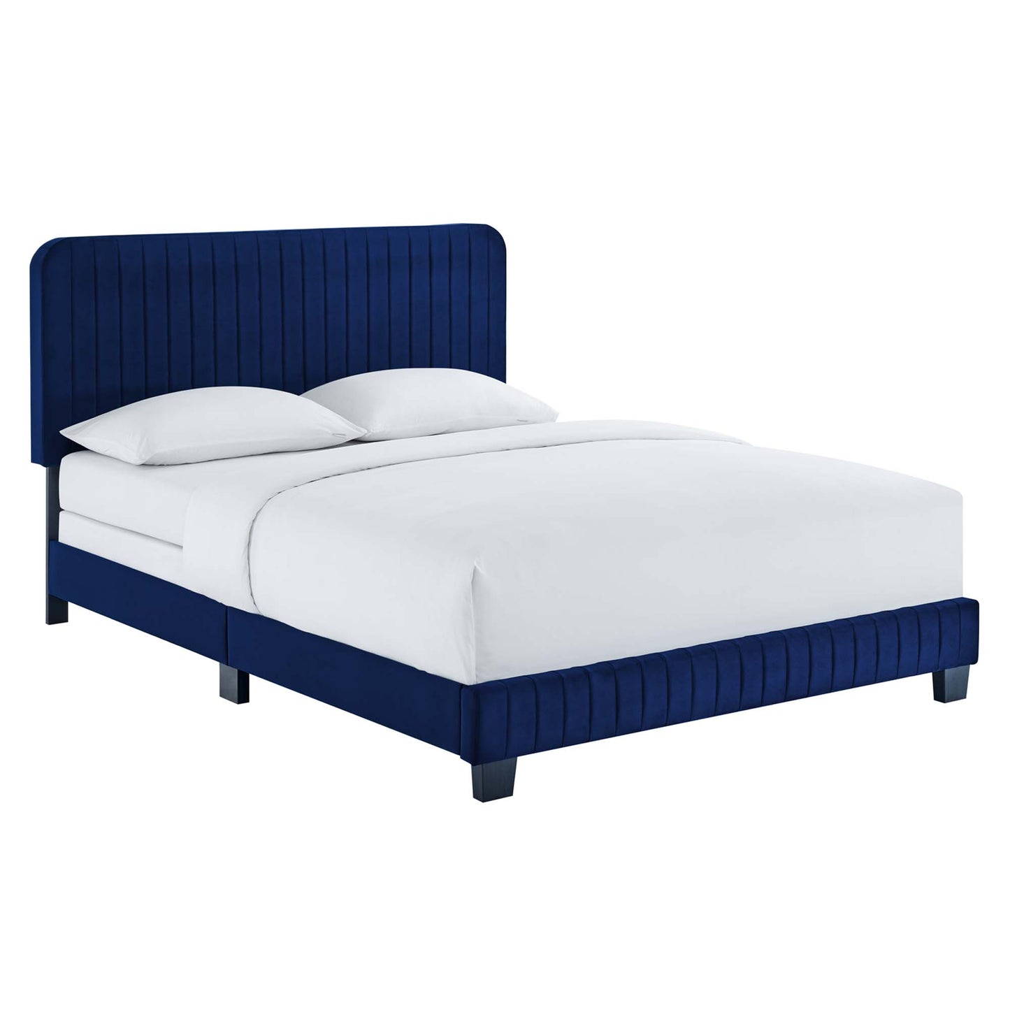 Navy blue velvet upholstered bed with tall, vertical tufted headboard and matching footboard, white bedding.