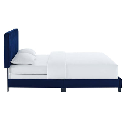 Navy blue upholstered bed with a tall headboard & white bedding, sleek silver legs.