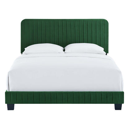 Emerald green velvet platform bed with tall, vertical-channel tufted headboard and dark legs, white bedding.