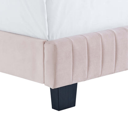 Blush pink velvet queen bed with vertical channel tufting on the headboard and dark square wood legs.