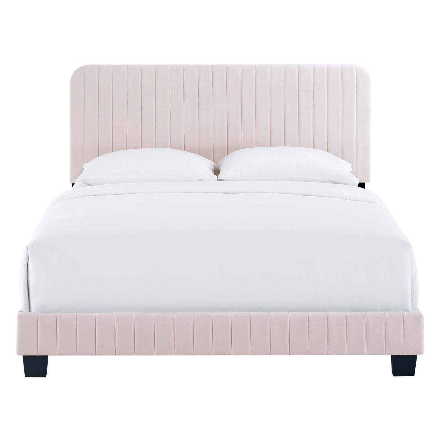 Soft blush pink upholstered platform bed with vertical channel tufted headboard and footboard, white bedding, dark legs.