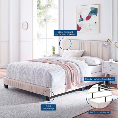 Soft pink velvet upholstered bed with tufted headboard and solid wood legs in a bright modern bedroom.