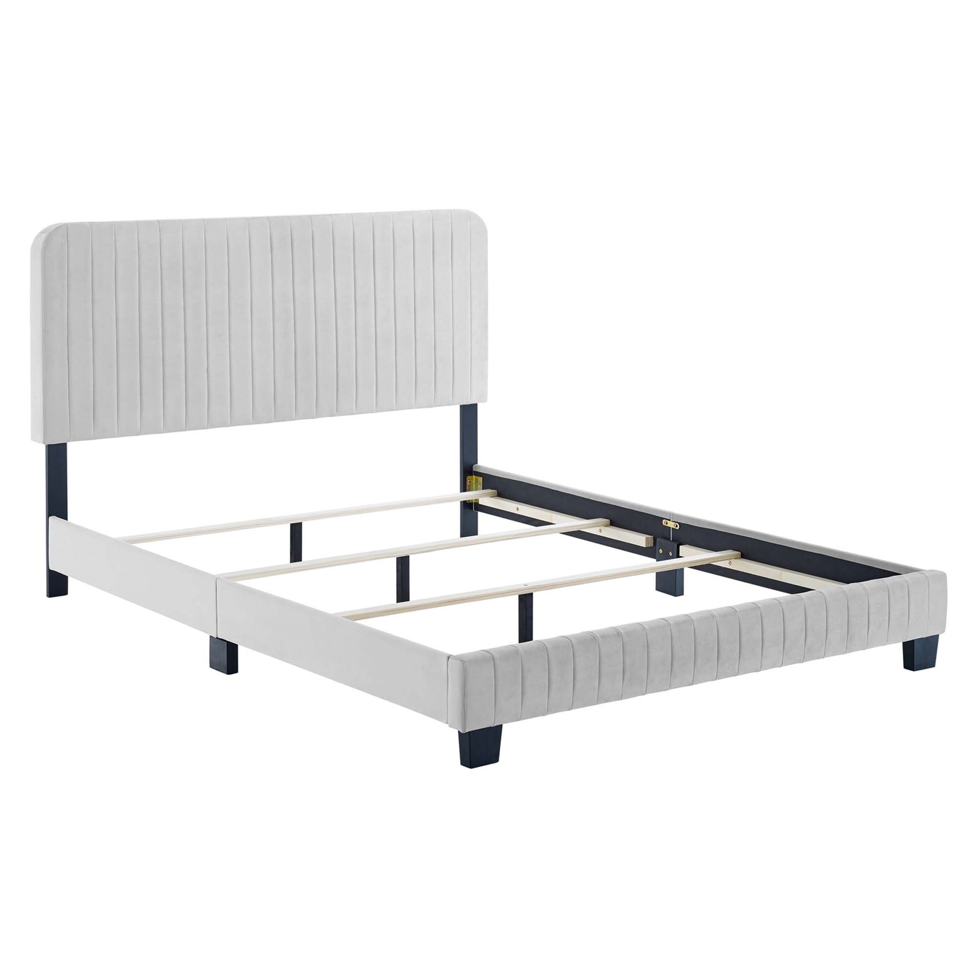 Light gray upholstered full bed with vertical-channel headboard, navy legs, and wooden slat support.