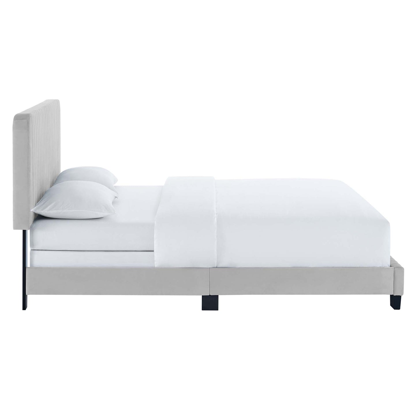 Light gray upholstered platform bed with tall tufted headboard, white bedding and two pillows.