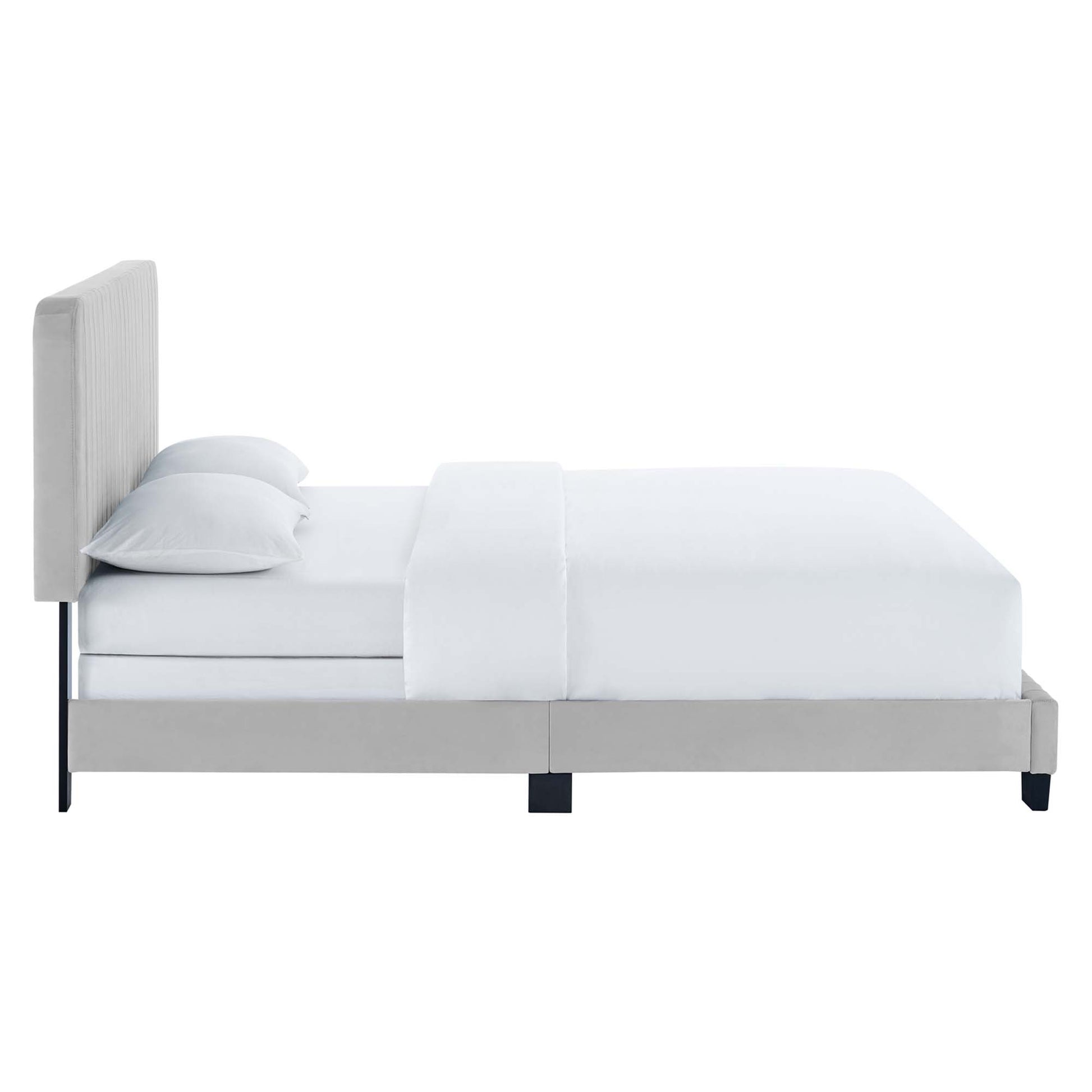 Light gray upholstered platform bed with tall tufted headboard, white bedding and two pillows.