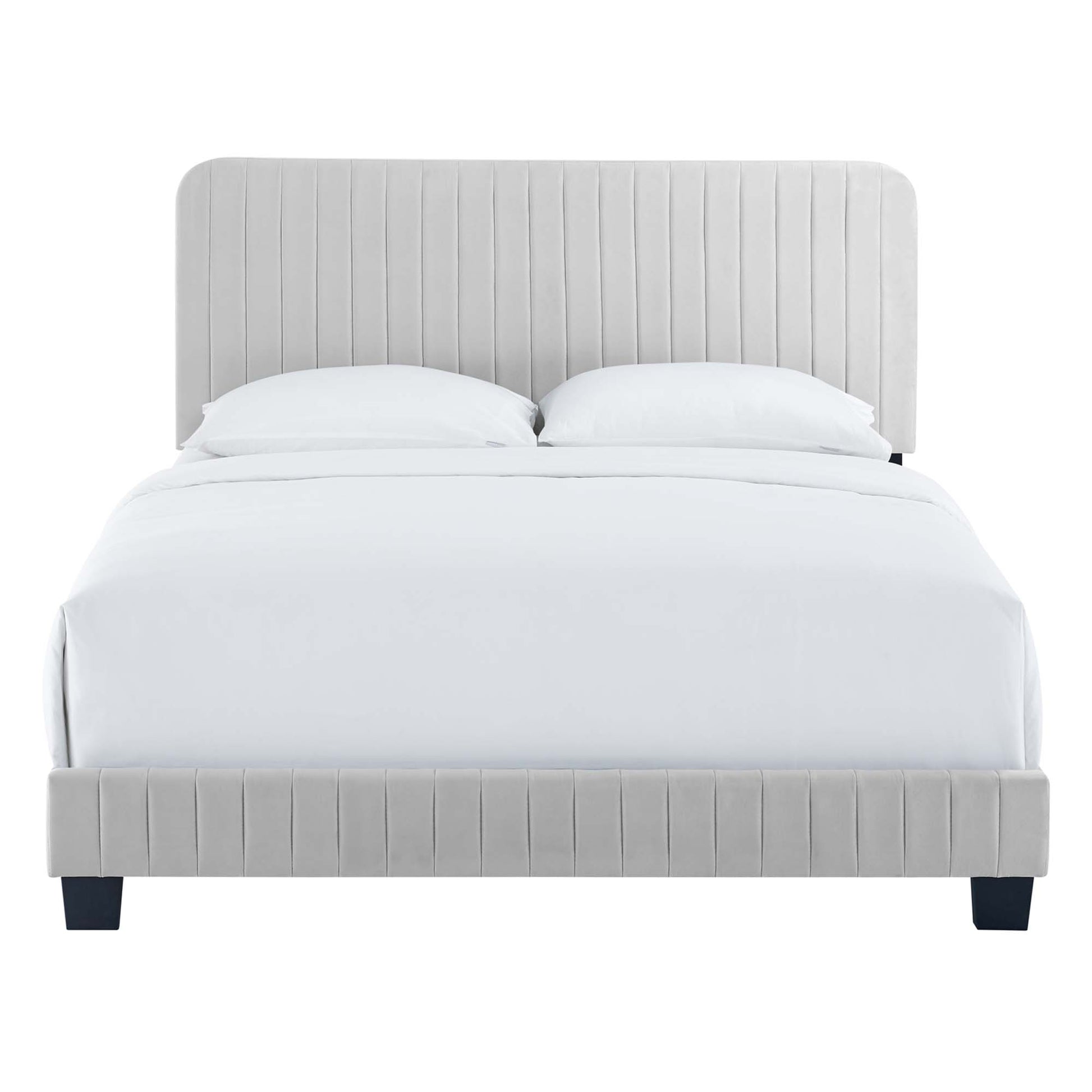 Light gray upholstered bed with vertical-channel headboard and footboard, white linens and dark legs.