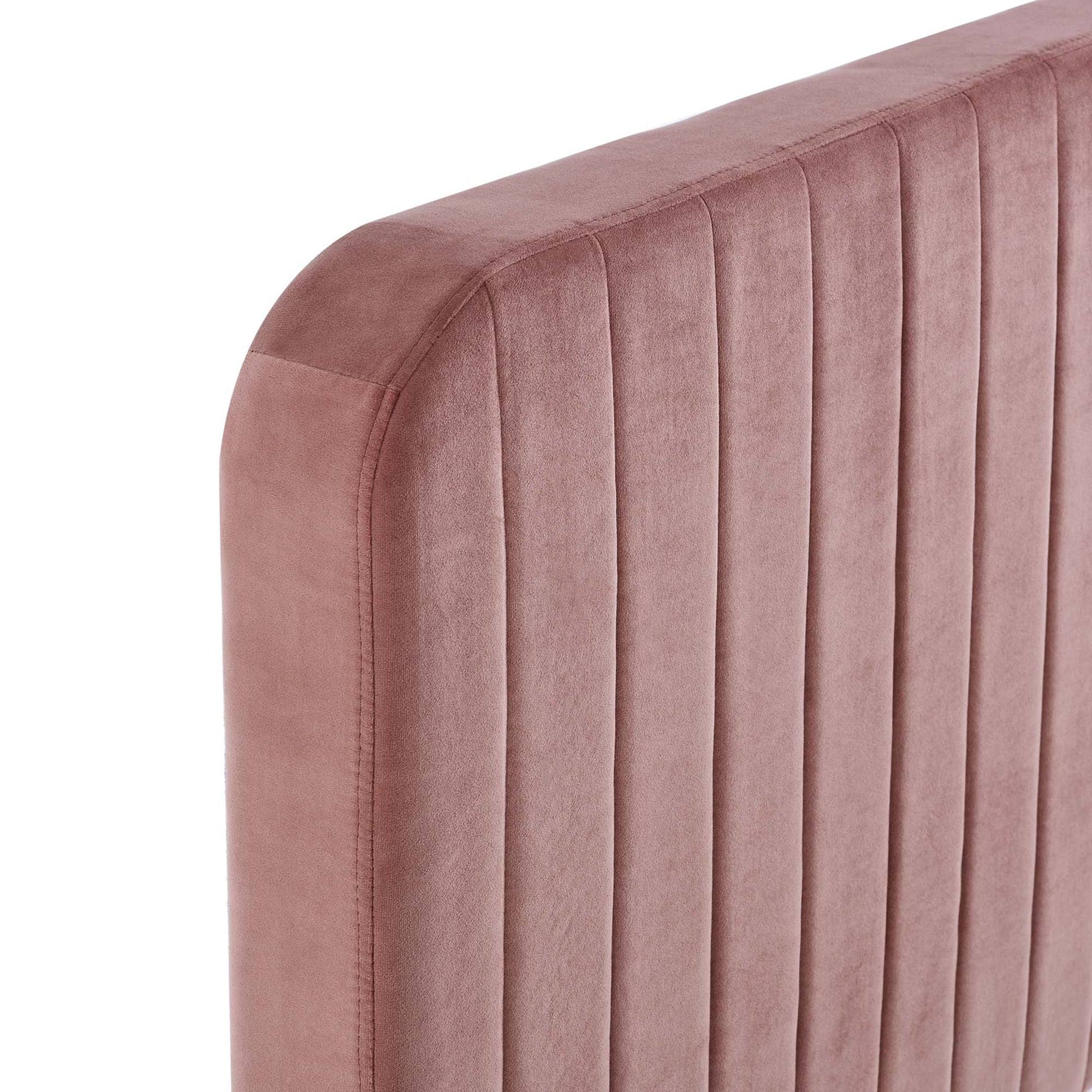 Dusty-rose velvet upholstered twin bed with a headboard featuring vertical channel tufting and rounded corners.