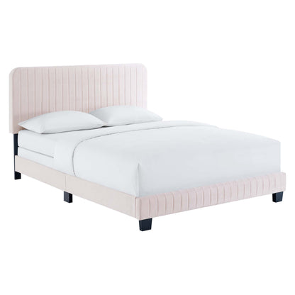 Soft pink fabric upholstered platform bed with vertical channel tufting on headboard and footboard, white bedding, black block legs.
