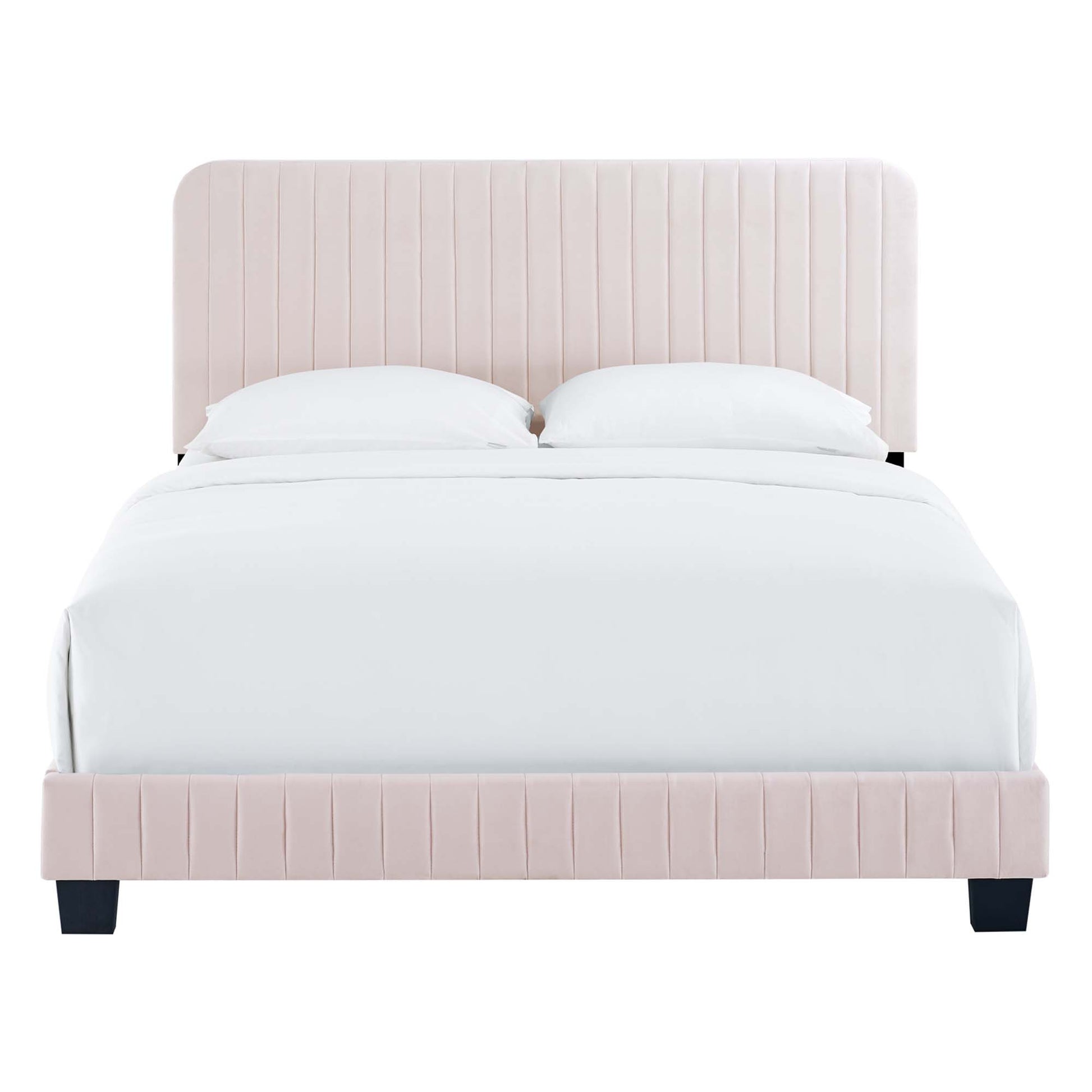 Pink upholstered twin bed with vertical channel-tufted headboard and white bedding.