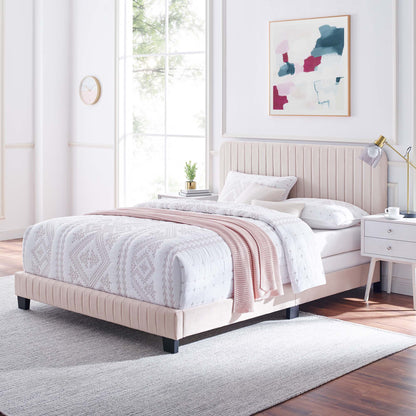 Red upholstered platform twin bed with tufted headboard in a modern bedroom, with a white geometric quilt and a blush knit throw.