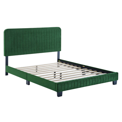 Green velvet upholstered platform bed with tall channel-tufted headboard, low footboard, dark legs, and wooden slat base.