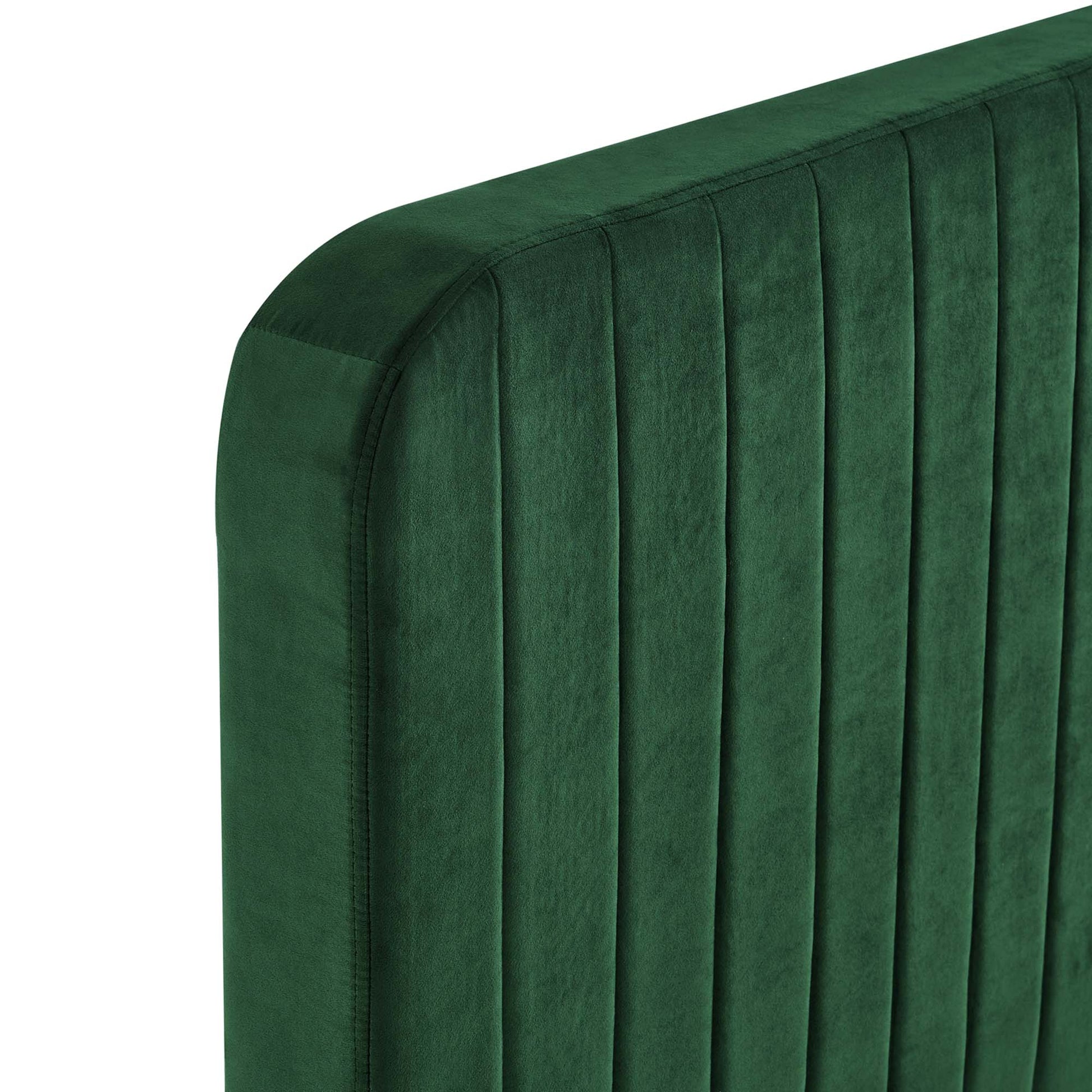 Emerald green velvet king platform bed with a vertical channel-tufted headboard.