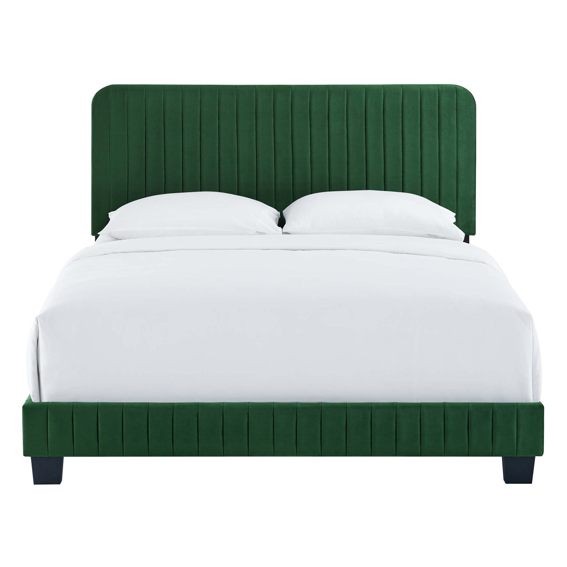 Emerald green velvet upholstered bed with tall vertical-channel headboard and matching footboard, white linens.