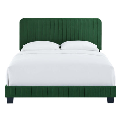 Emerald green velvet upholstered bed with tall vertical-channel headboard and matching footboard, white linens.