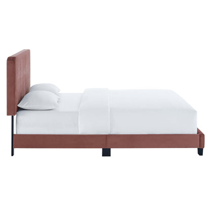 Rust-red upholstered platform bed with tall padded headboard, white sheets, and black legs.