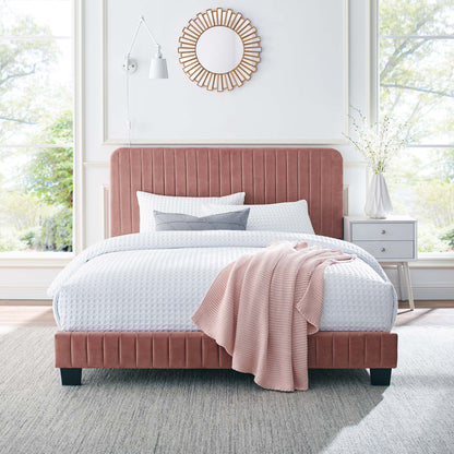 Red velvet queen platform bed with white waffle bedding, gray pillows, blush knit throw; sunburst mirror, gray nightstand.