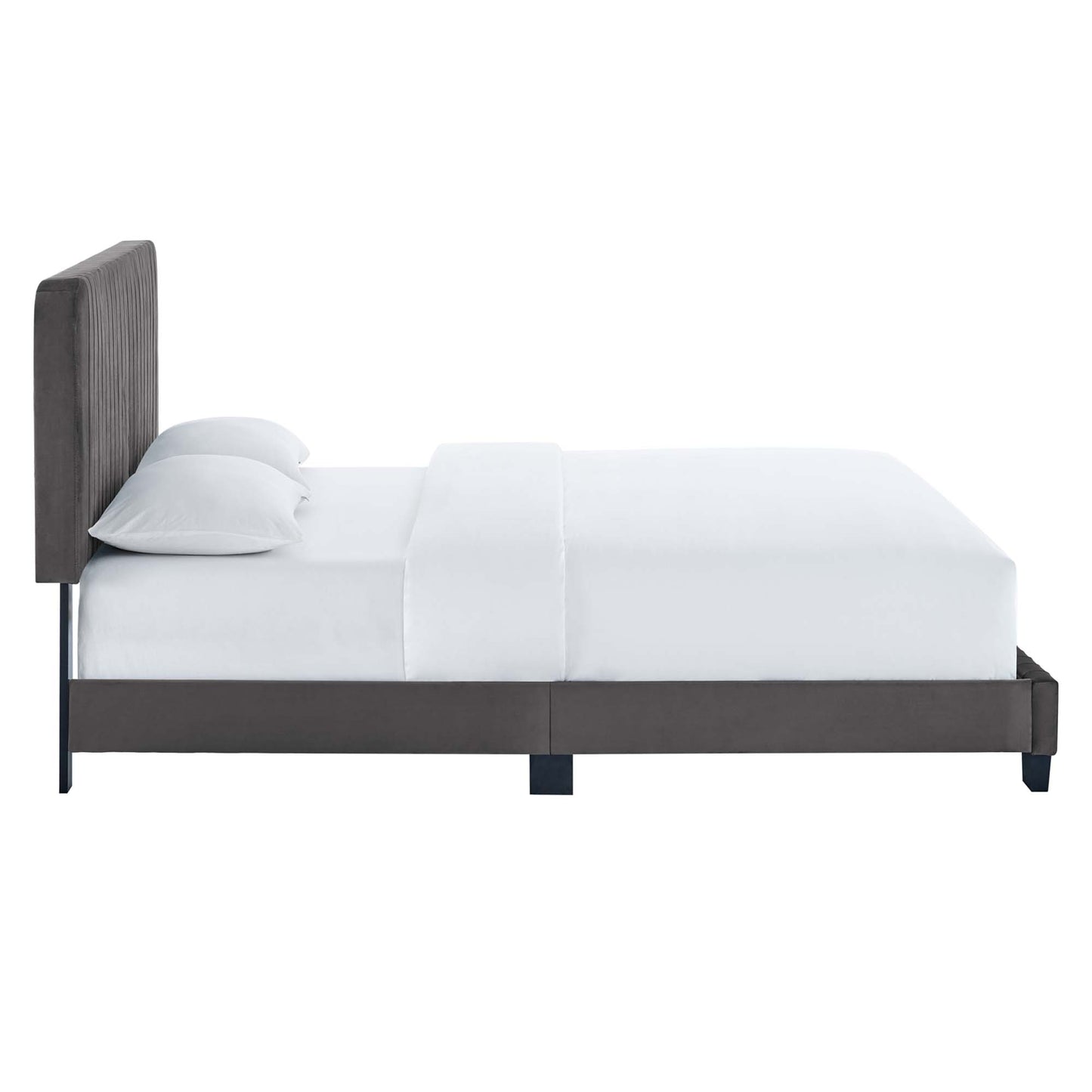 Gray upholstered platform bed with tall tufted headboard, white bedding, dark frame and legs.