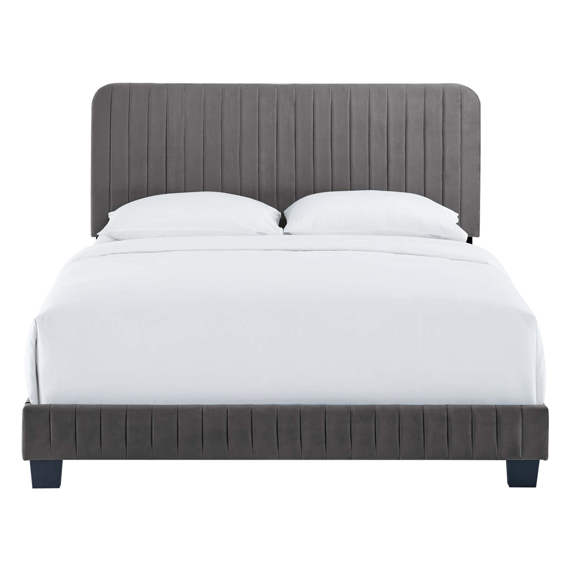 Grey upholstered platform bed with vertical channel tufting on headboard and footboard, white bedding, short dark legs.
