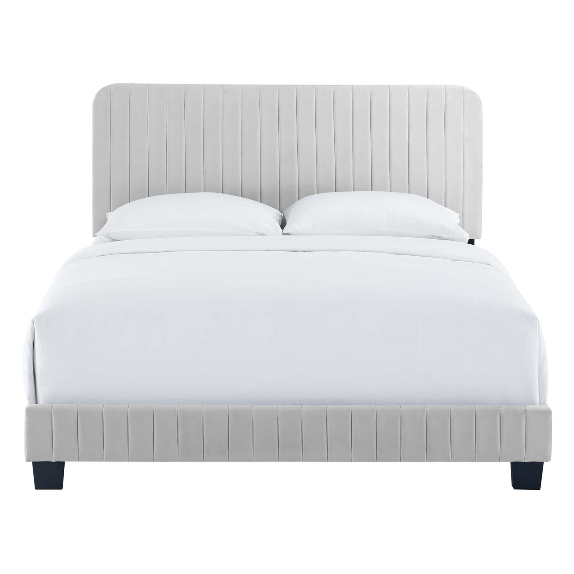 Grey upholstered platform bed with tall channel-tufted headboard and matching footboard, white bedding.