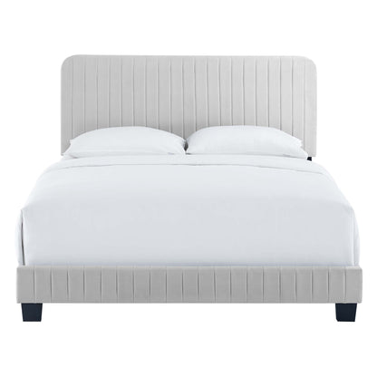 Grey upholstered platform bed with tall channel-tufted headboard and matching footboard, white bedding.
