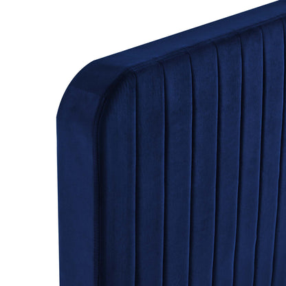 Navy blue velvet upholstered full platform bed with vertical channel tufting on the headboard and rounded corners.