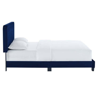 Navy blue upholstered platform bed with tall headboard, white bedding, metal legs, modern contemporary bedroom furniture.