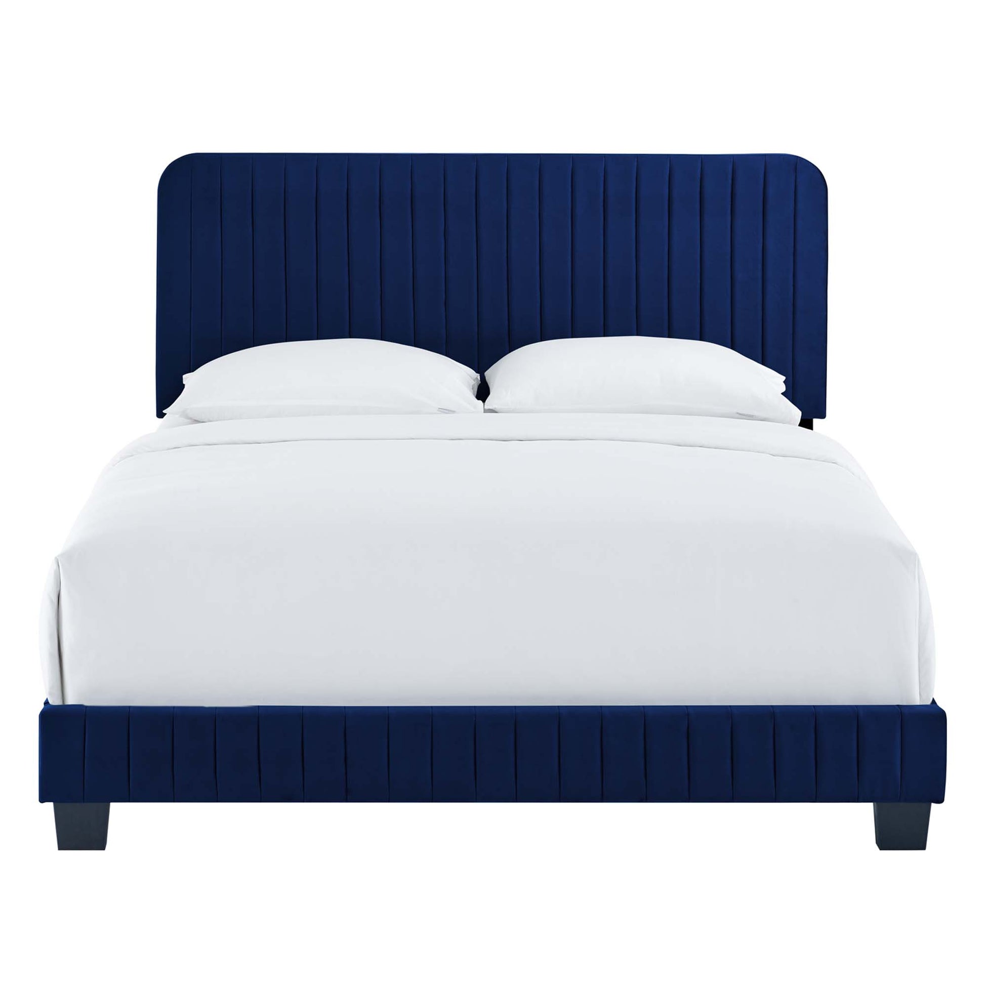 Navy blue upholstered bed with tall vertical-channel tufted headboard and footboard, white bedding.