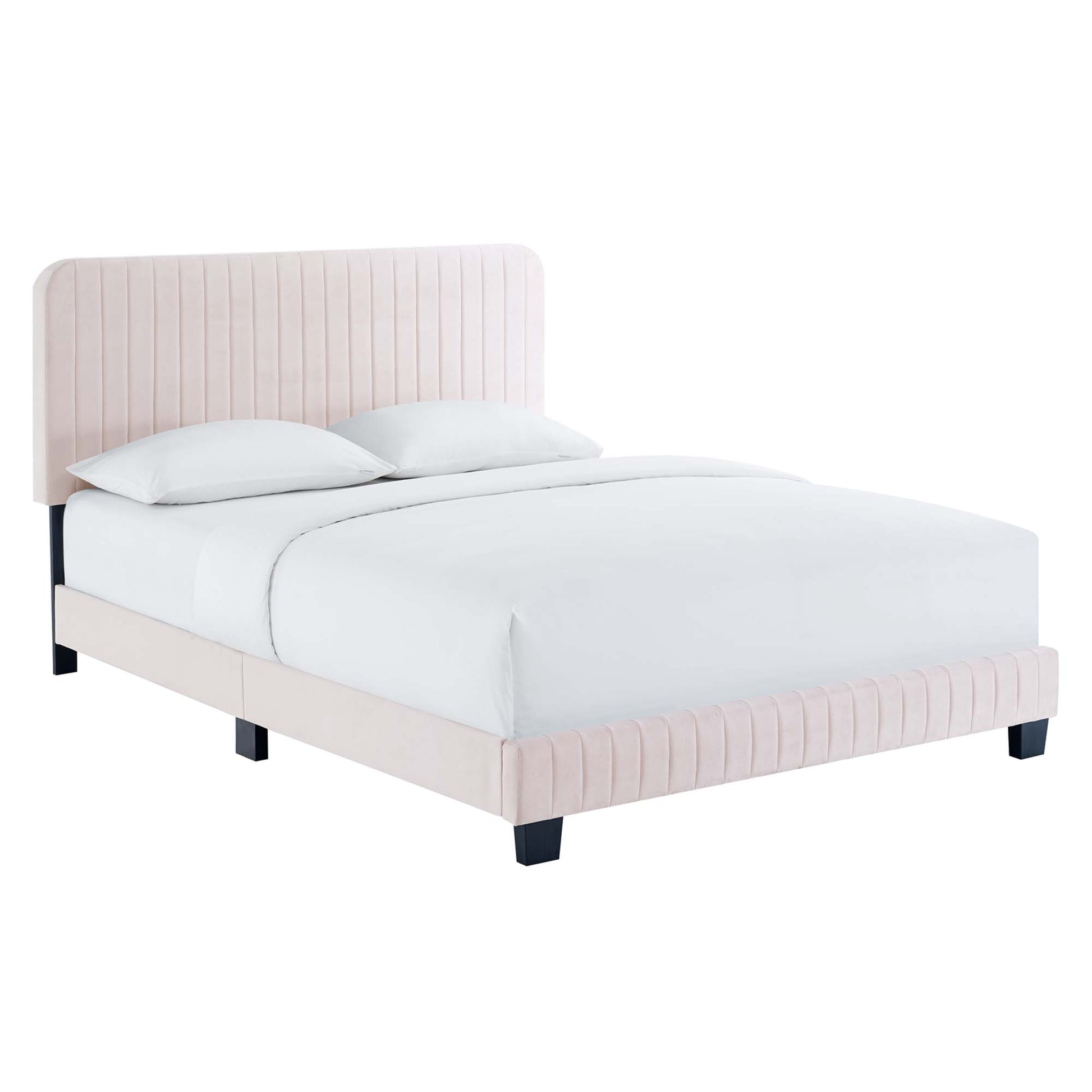 Blush pink upholstered platform bed with vertical channel tufting on headboard and footboard, black legs, white bedding.