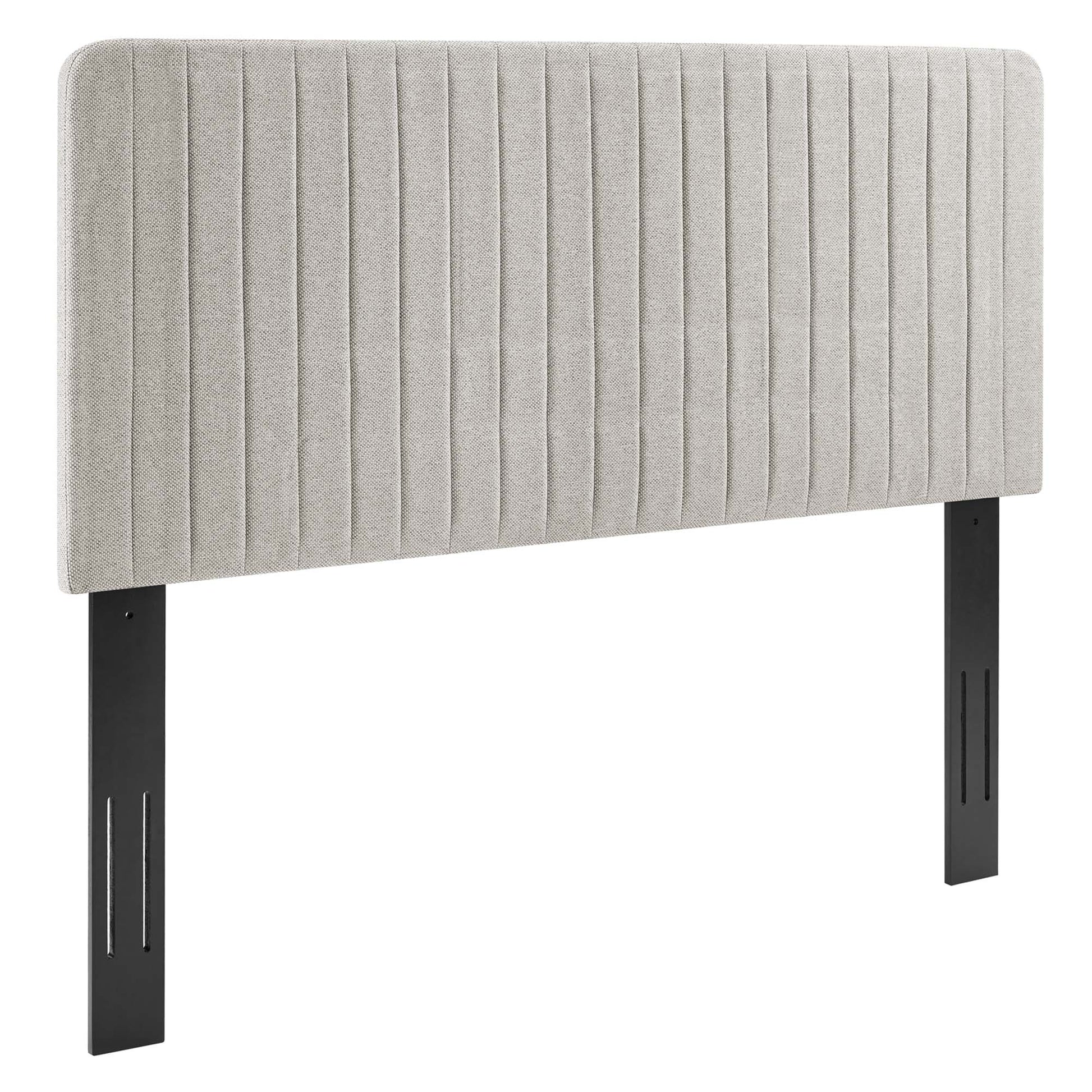 Oat fabric upholstered headboard with vertical channel tufting and black metal legs.