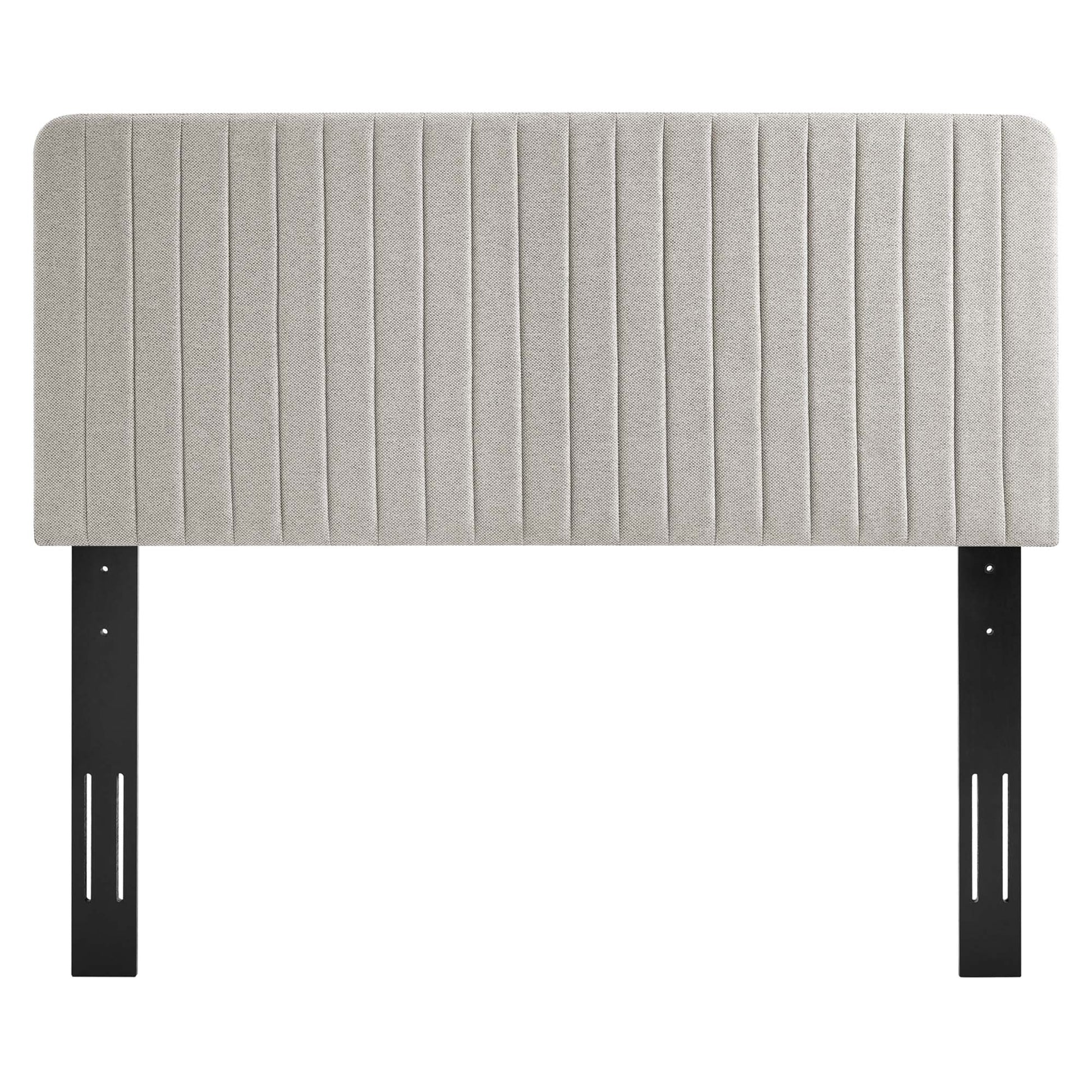 Oatmeal upholstered headboard with vertical channel tufting and black metal mounting brackets.