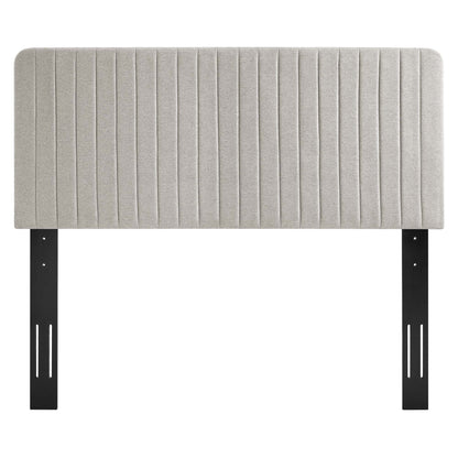 Oatmeal upholstered headboard with vertical channel tufting and black metal mounting brackets.