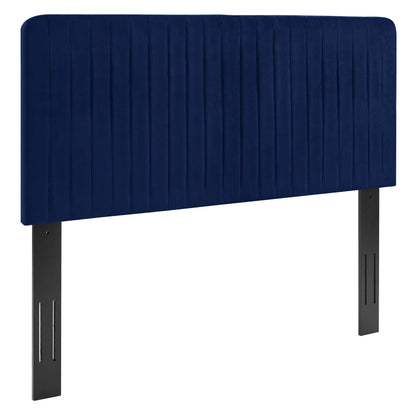 Navy blue upholstered headboard with vertical channel quilting and dark metal legs.