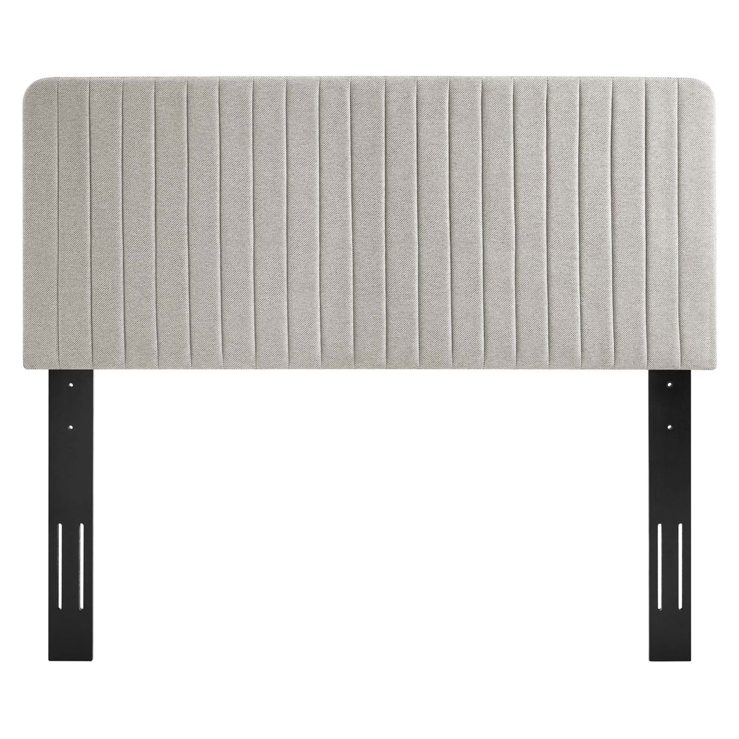 Oat-colored upholstered headboard with vertical channel tufting and black metal mounting legs.