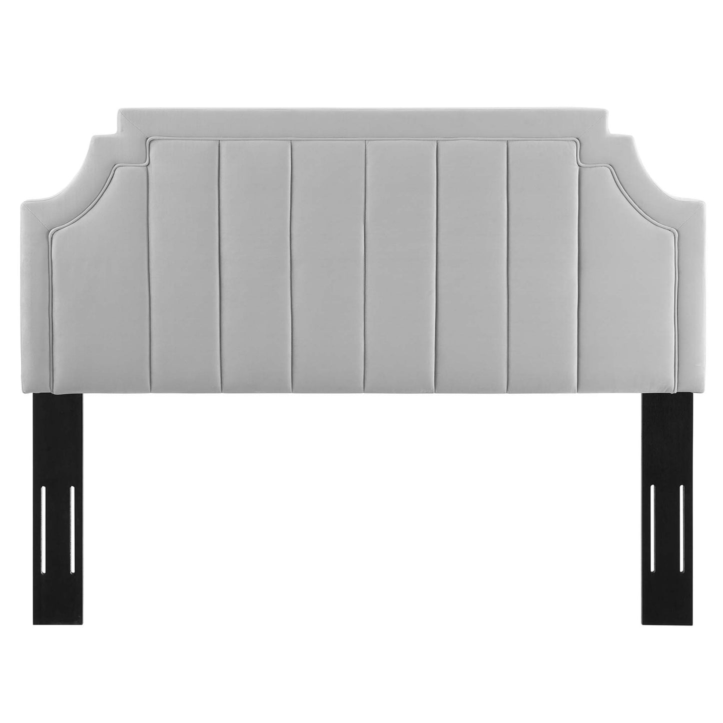 Light gray upholstered headboard with vertical channel tufting, curved side details and black metal legs.