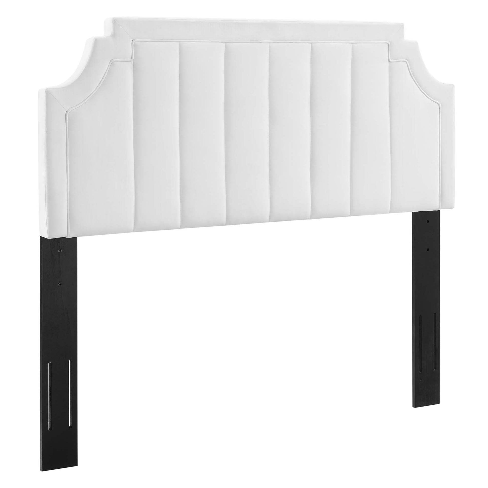 White upholstered headboard with vertical channel tufting, curved side corners, and black rectangular legs.