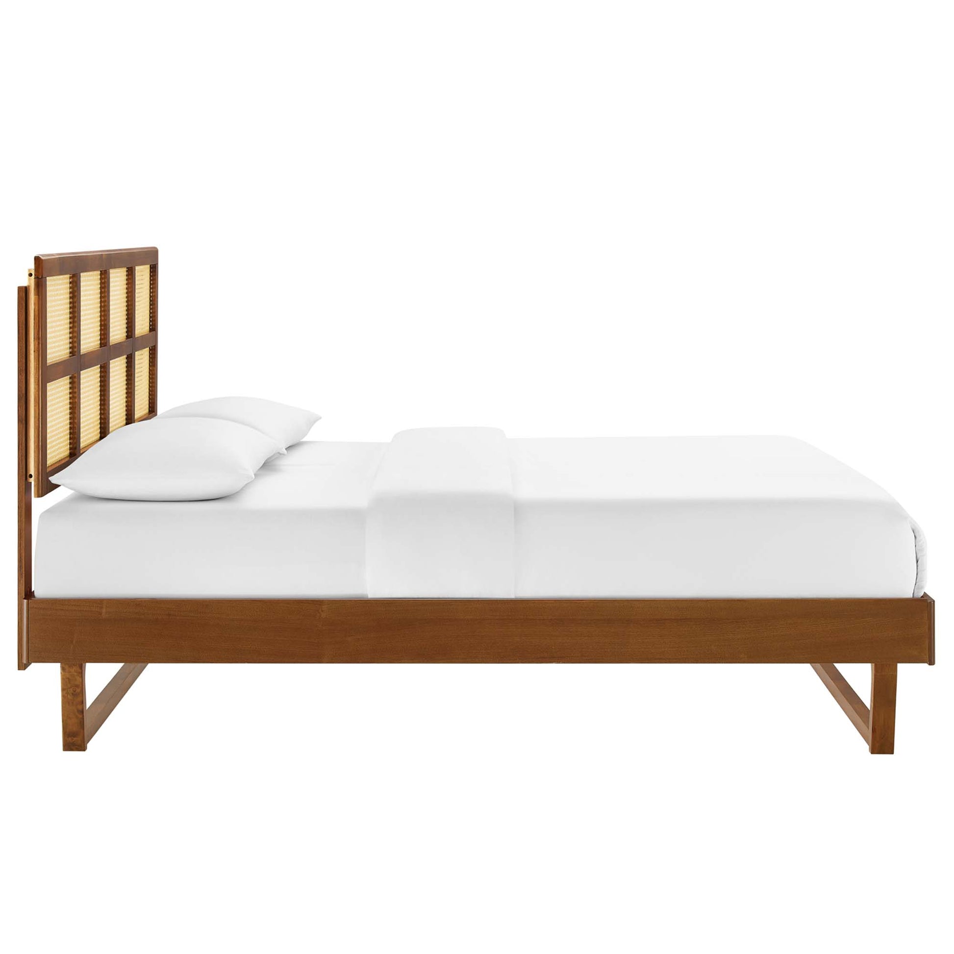 Walnut wood bed frame with a woven cane headboard, mid-century modern style, white bedding.