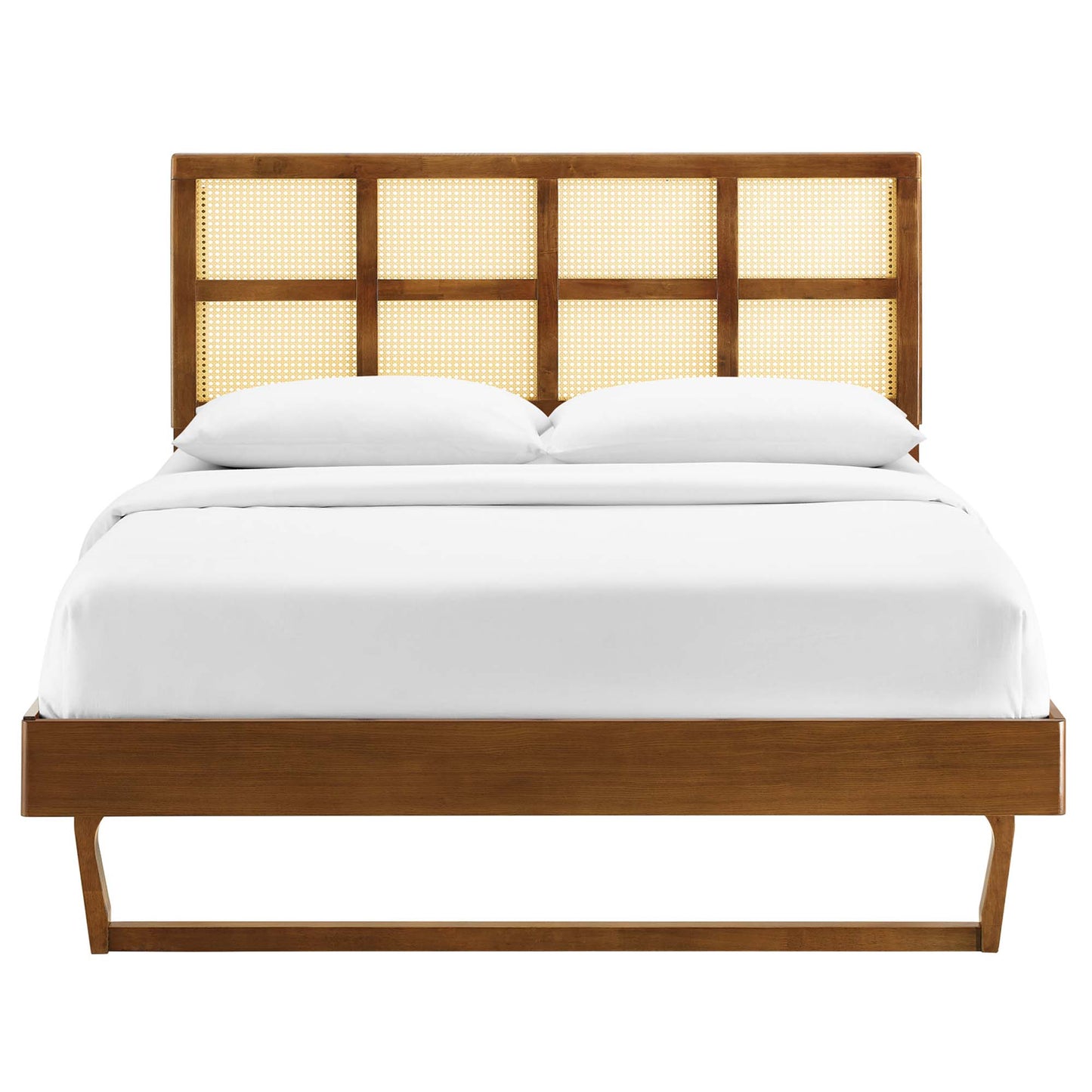 Walnut platform bed with four-panel caned headboard, low footboard, angled legs, and white bedding.