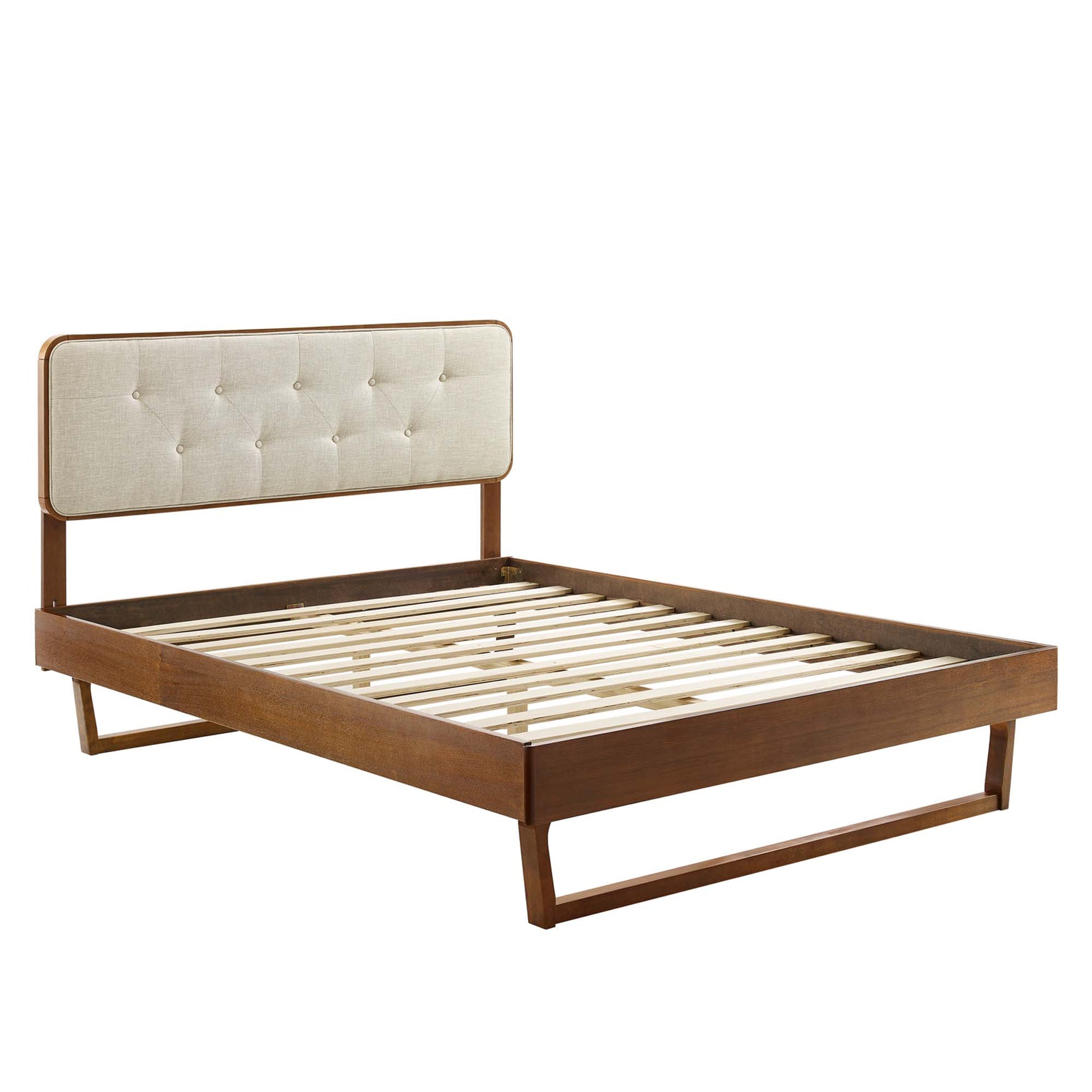Walnut platform bed with beige tufted headboard and slatted base, mid-century inspired.
