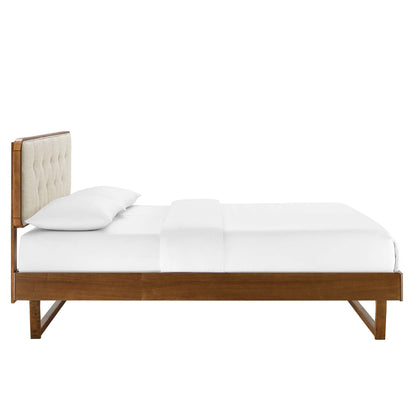 Walnut wood queen platform bed with an angular frame and white bedding.