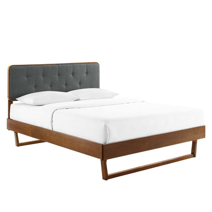 Walnut wood queen platform bed with dark gray tufted headboard and white bedding, modern minimalist design.