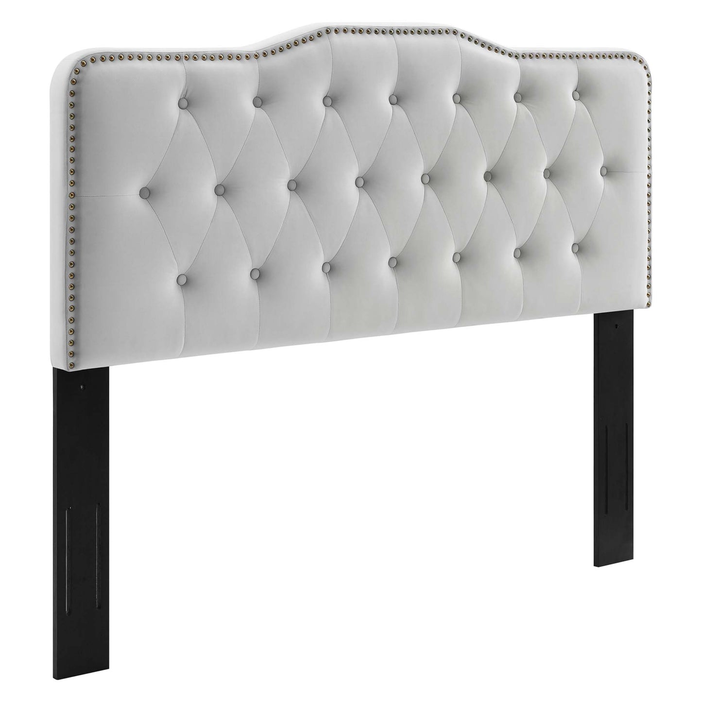 Light gray tufted upholstered headboard with diamond pattern and nailhead trim, curved top, supported by black legs.