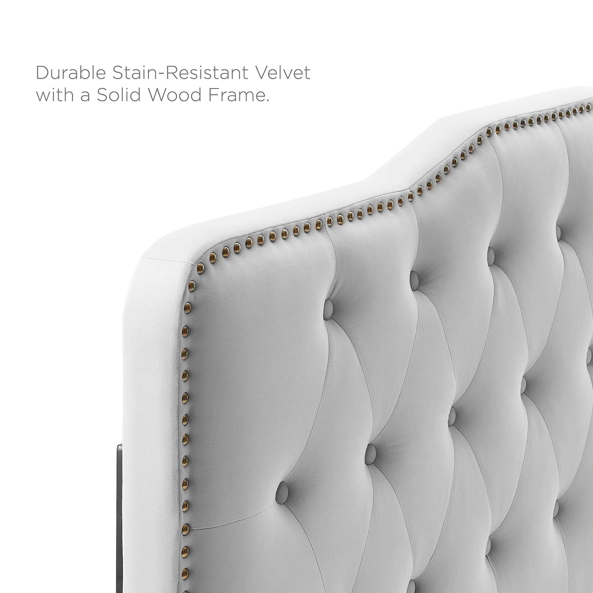 Light gray velvet tufted headboard with button-tufted panels, nailhead trim, and a solid wood frame.