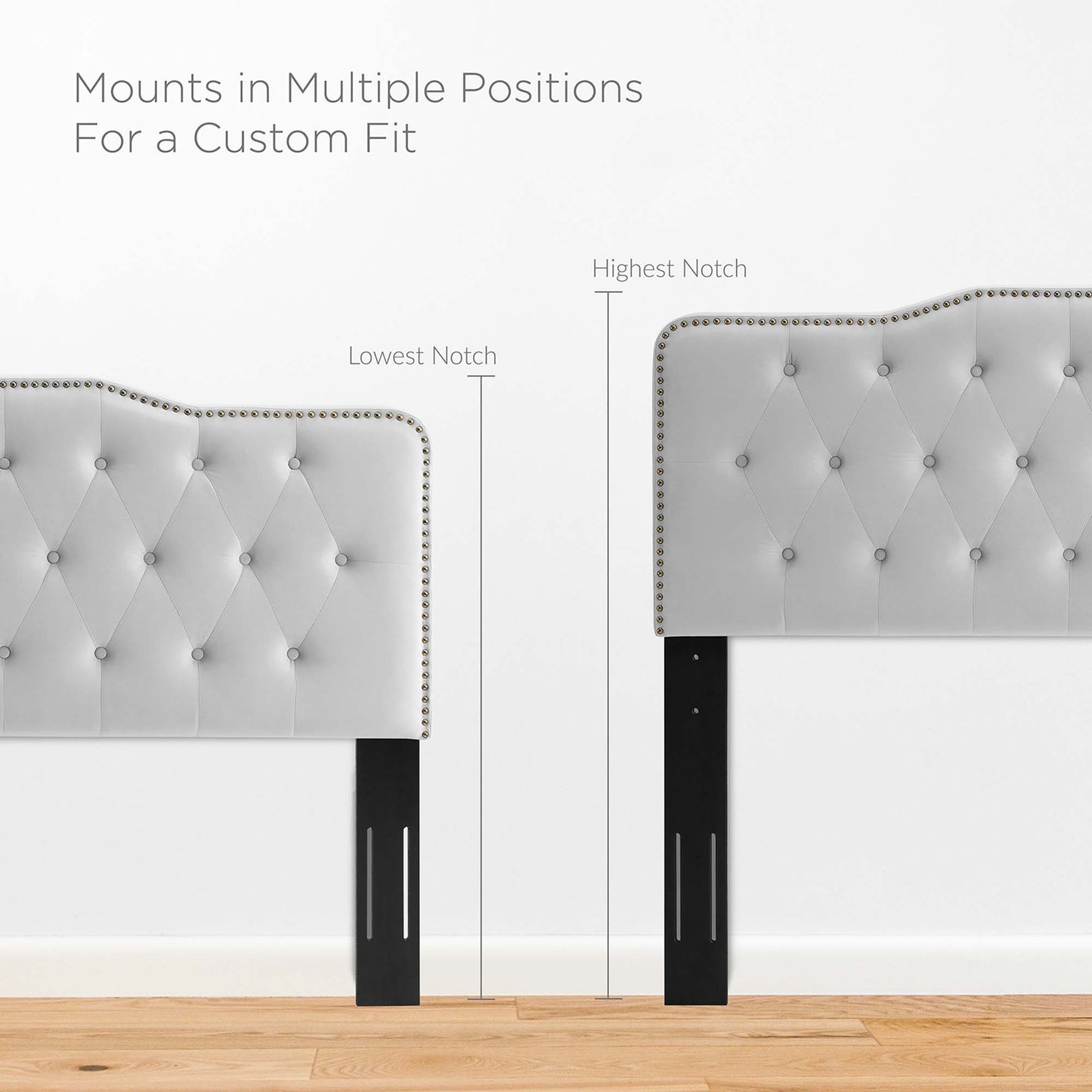 Tufted light gray upholstered headboard with nailhead trim and black slotted legs; mounts in multiple notch positions.
