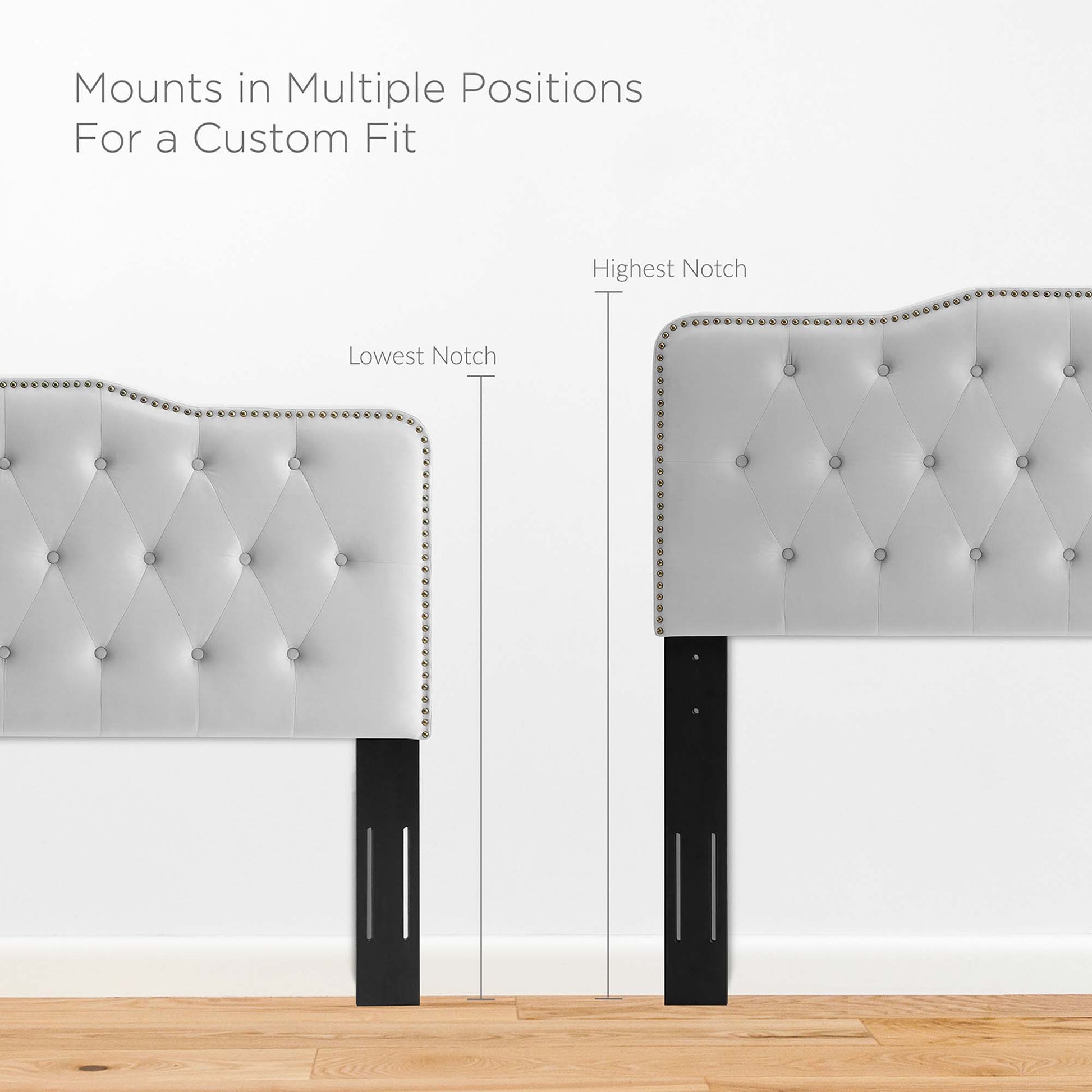 Tufted light gray upholstered headboard with nailhead trim and black slotted legs; mounts in multiple notch positions.