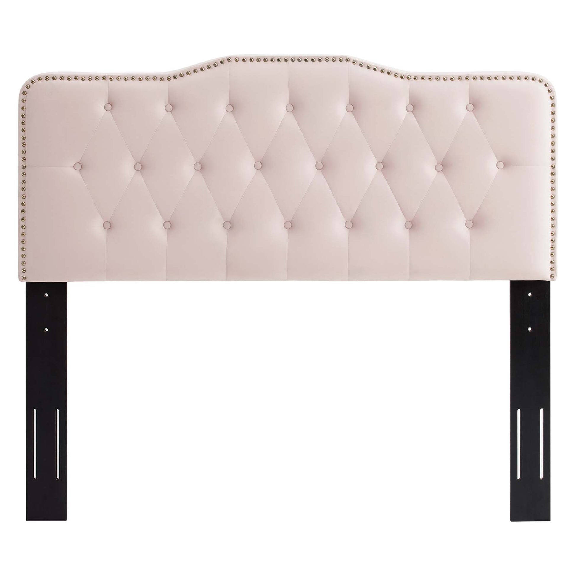 Blush pink tufted headboard with diamond stitching, nailhead trim, curved top, supported by dark wooden legs.