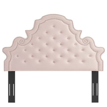 Red tufted upholstered headboard with ornate scalloped silhouette and nailhead trim, supported by black metal legs.