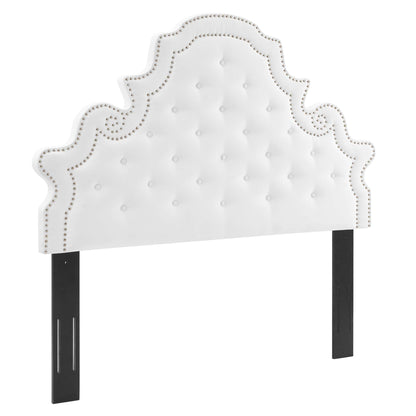 White tufted velvet headboard with nailhead trim and ornate scalloped silhouette on black legs