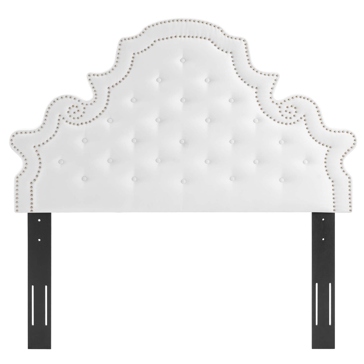 White tufted headboard with ornate curved silhouette and nailhead trim, mounted to black metal posts.