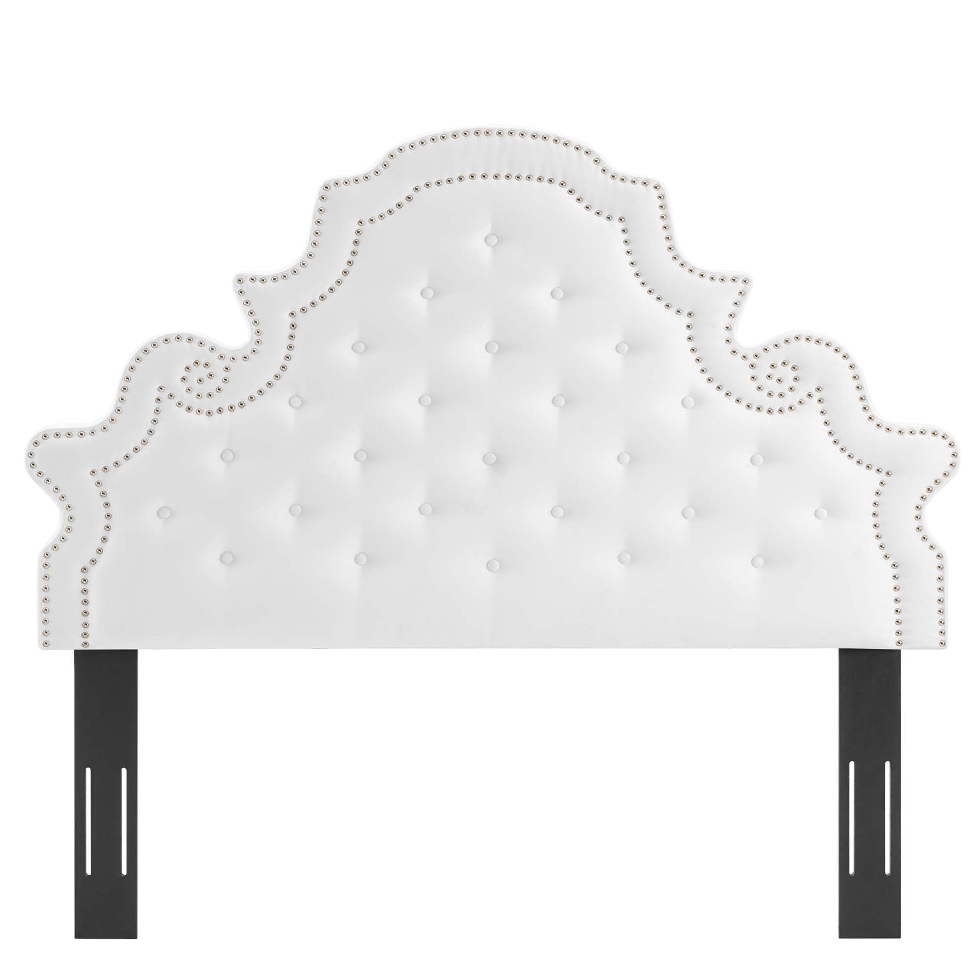 White tufted headboard with nailhead trim & scalloped silhouette, supported by black metal posts.