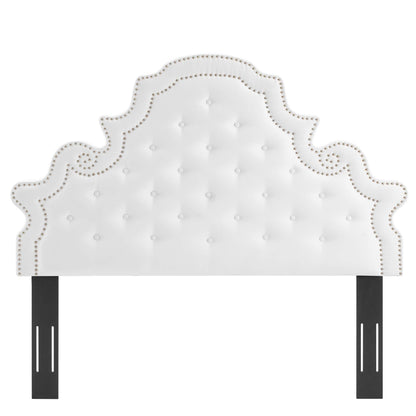 White tufted headboard with nailhead trim & scalloped silhouette, supported by black metal posts.